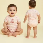 pink art in bloom baby bodysuit model view
